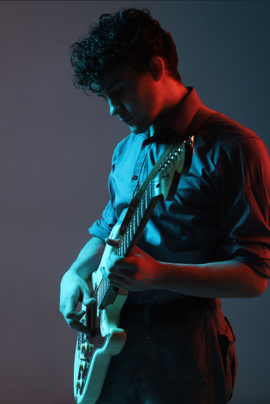 Harvey performing with coloured lighting